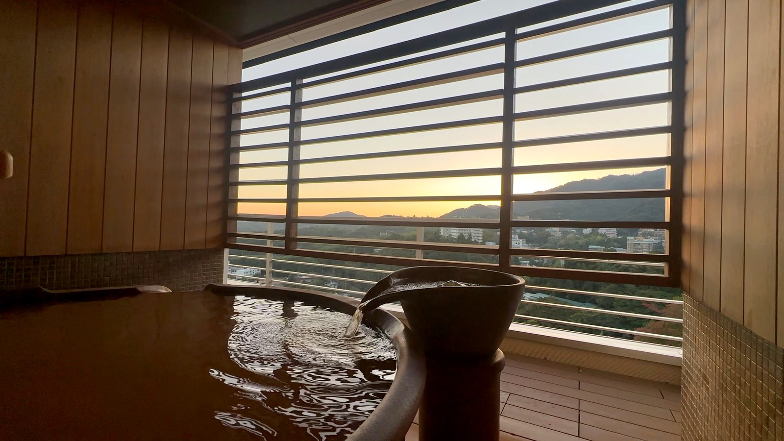 朝焼けの山と、光る湯面